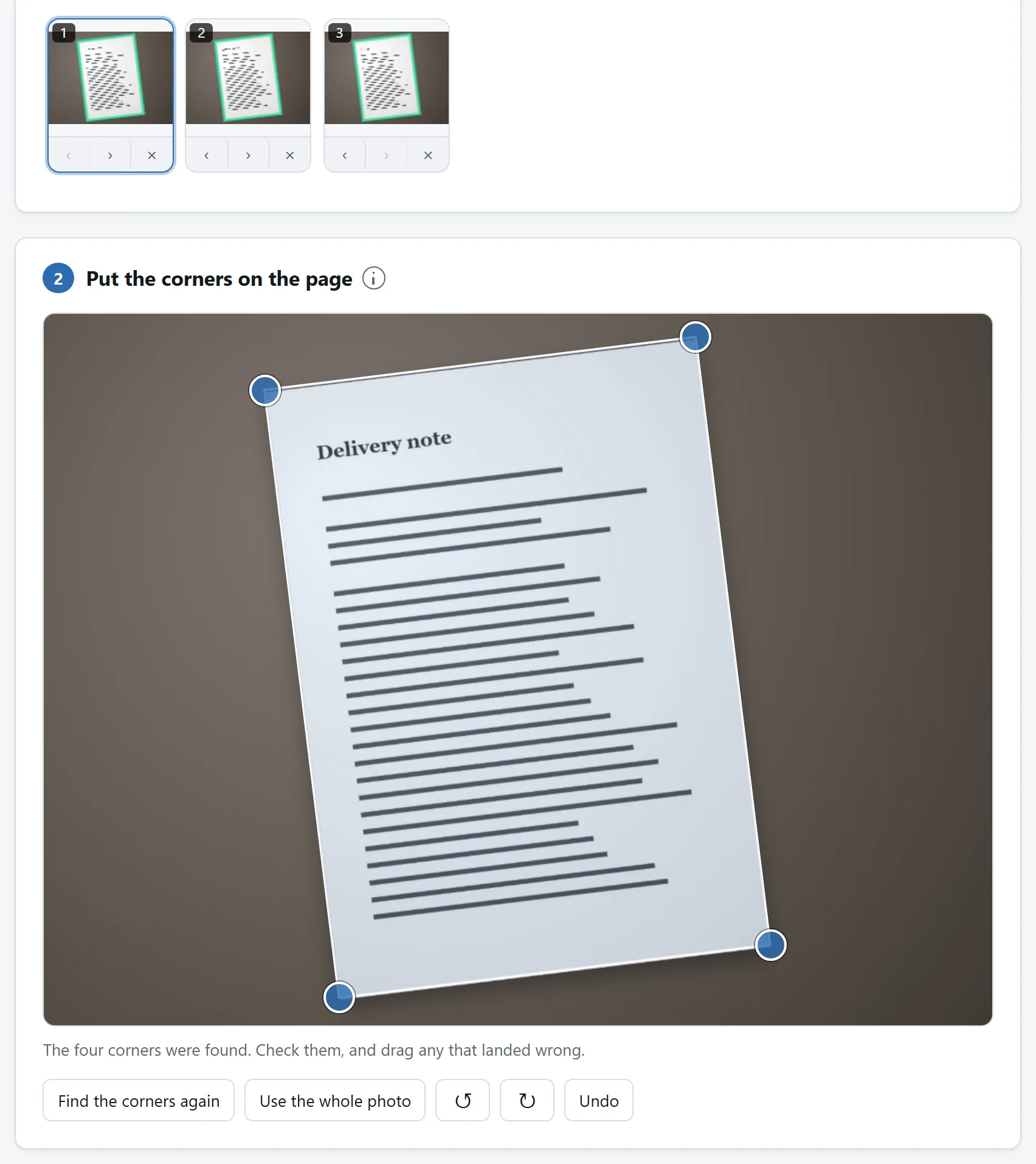 The scanner with three photographed pages in a strip, the first of them open with its corners marked.